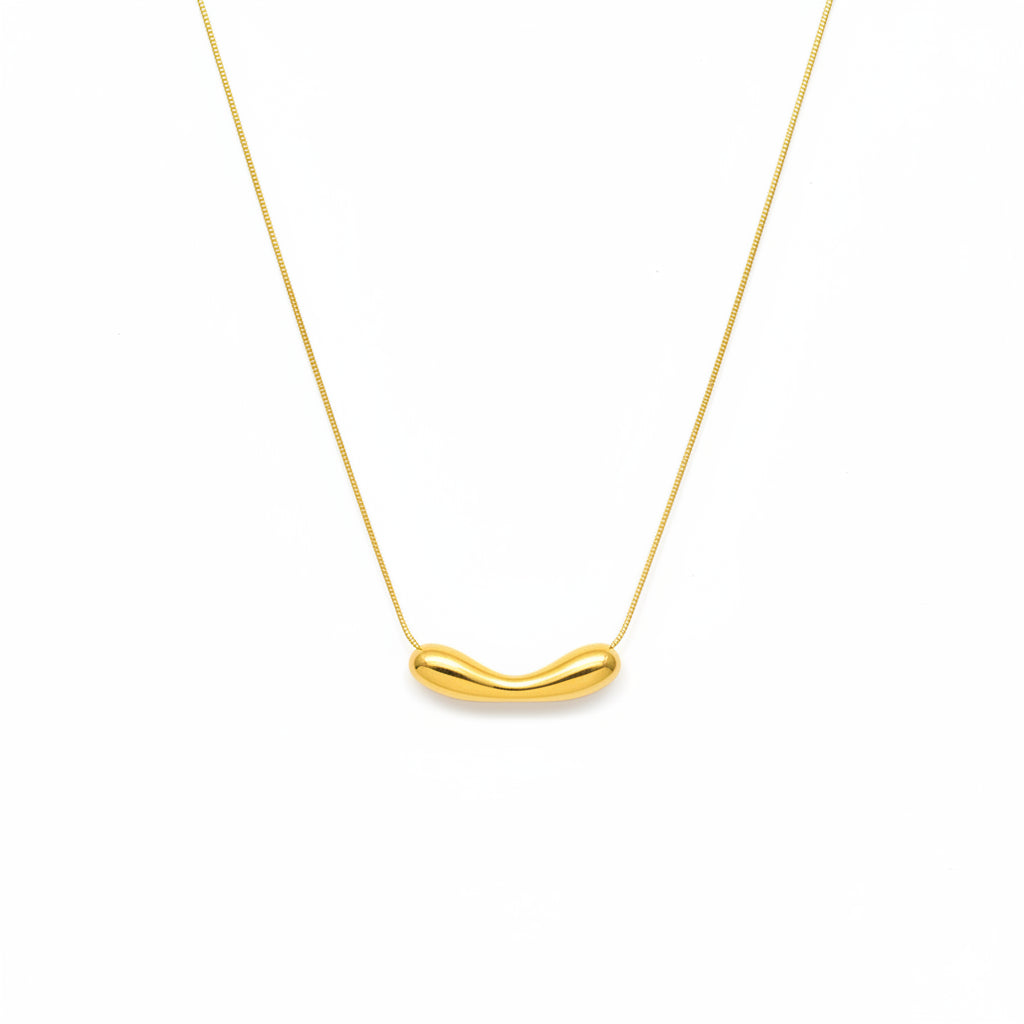 Gold necklace with a unique pendant on a white background