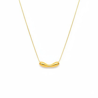 Gold necklace with a unique pendant on a white background