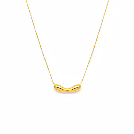 Gold necklace with a unique pendant on a white background
