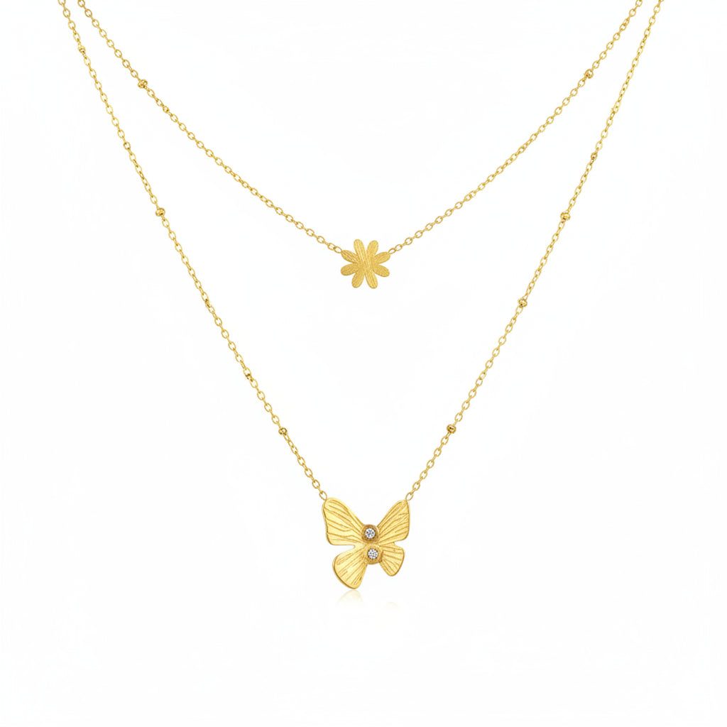 Two gold necklaces with a butterfly and flower pendant on a white background