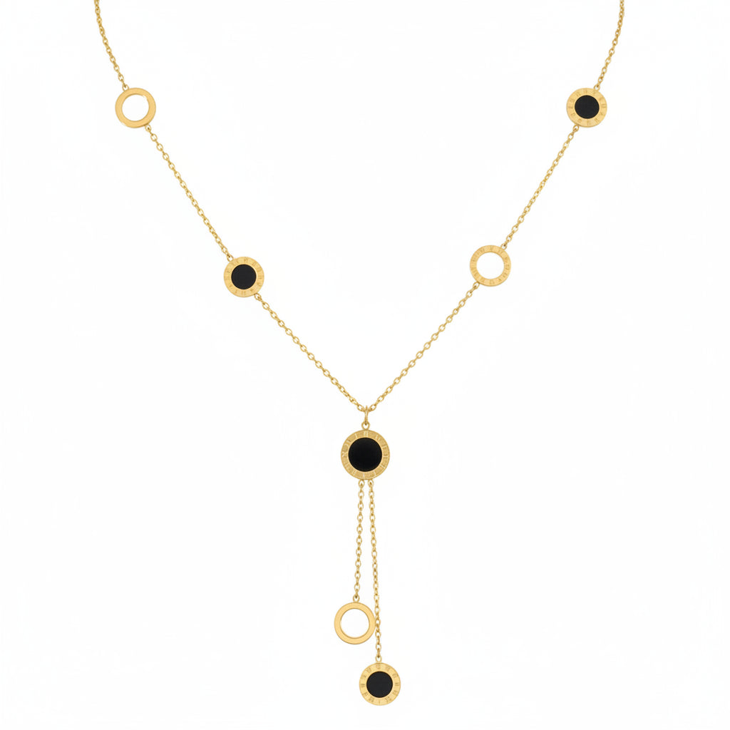 Gold necklace with black stones on a white background