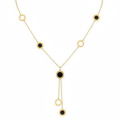 Gold necklace with black stones on a white background