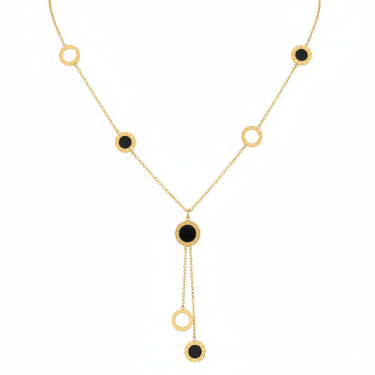 Gold necklace with black stones on a white background