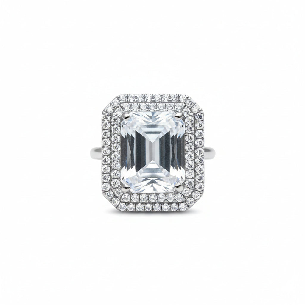 Diamond ring with a rectangular gemstone on a white background