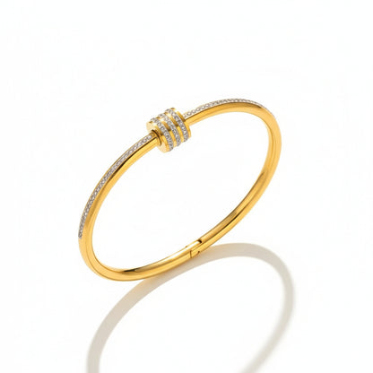 Gold bracelet with diamond accents on a white background