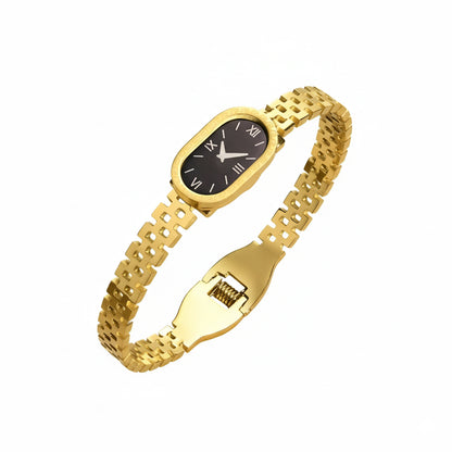 Gold wristwatch with a black face on a white background