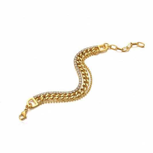 Gold chain bracelet with diamond accents on a white background
