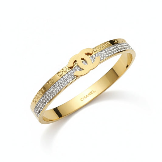 Gold bracelet with Chanel logo on a white background