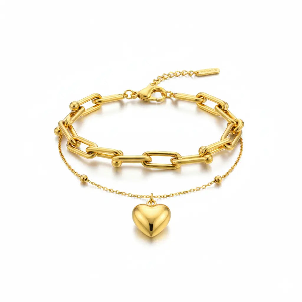 Gold chain bracelet with a heart-shaped pendant on a white background