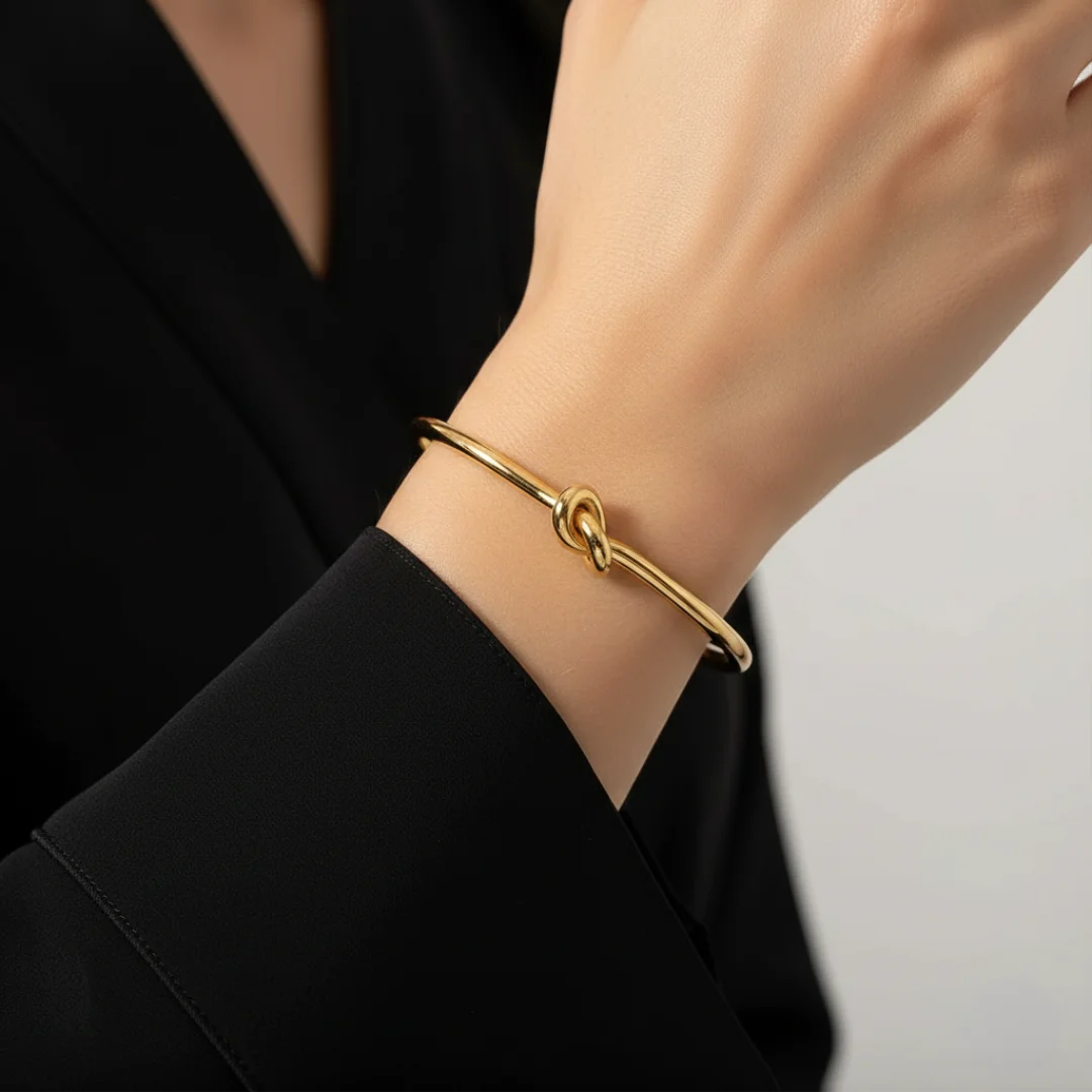 Gold bracelet on a person's wrist with a blurred background