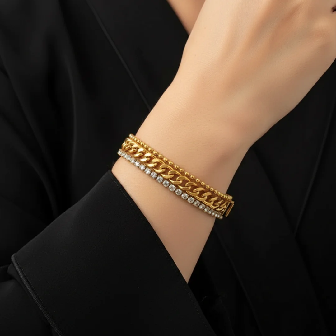 Gold bracelet with diamonds on a person's wrist against a black background