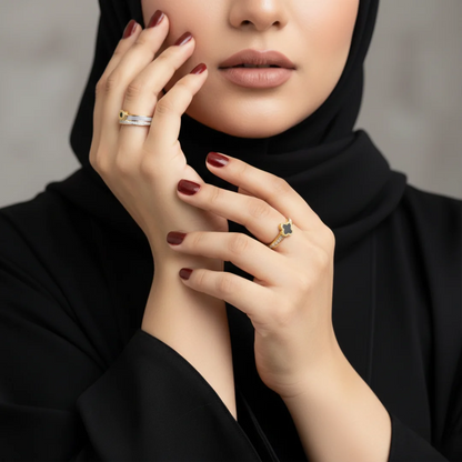 Woman wearing gold rings with a neutral background