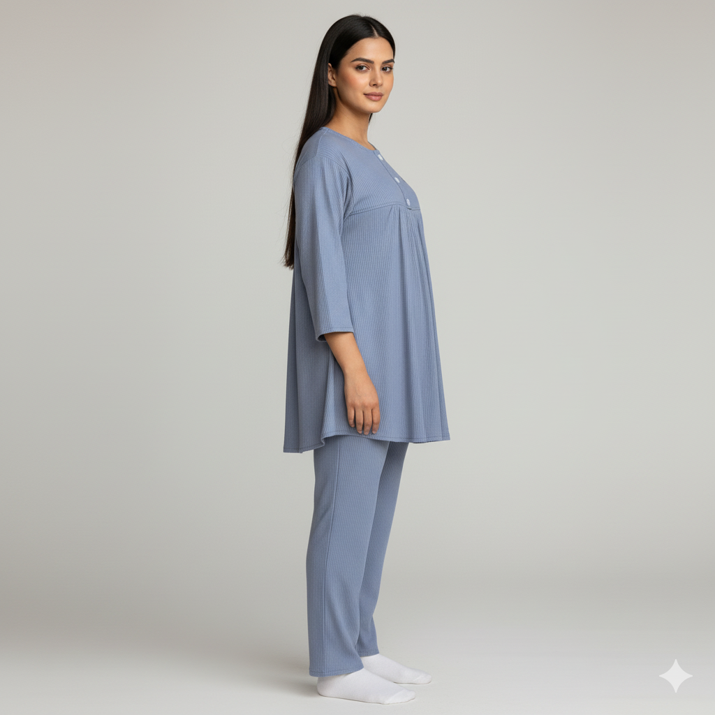 Woman wearing a blue pajama set on a plain background