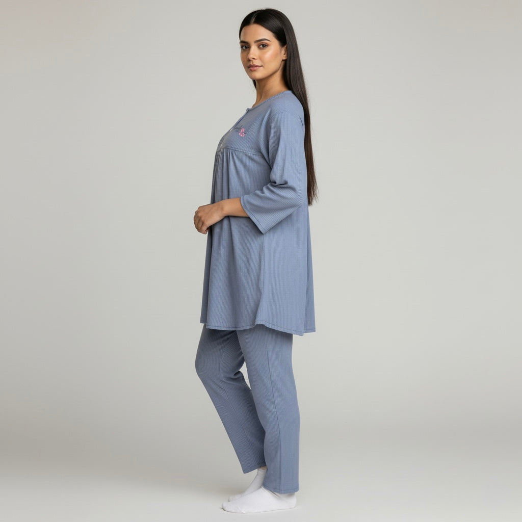 Woman wearing a blue outfit on a plain background