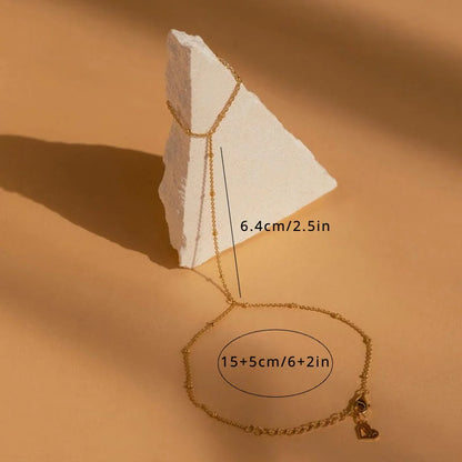 Gold necklace with measurements on a beige background