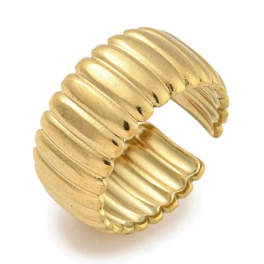 Gold ribbed ring on a white background