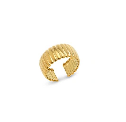 Gold ring with ribbed texture on a white background