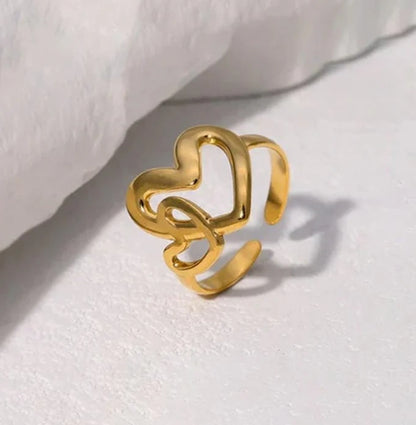 Gold heart-shaped ring on a white background