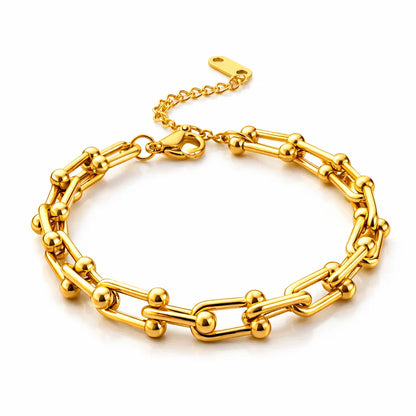 Gold chain bracelet on a white background