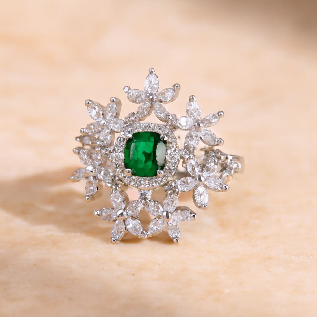 Diamond ring with a central emerald stone on a beige background