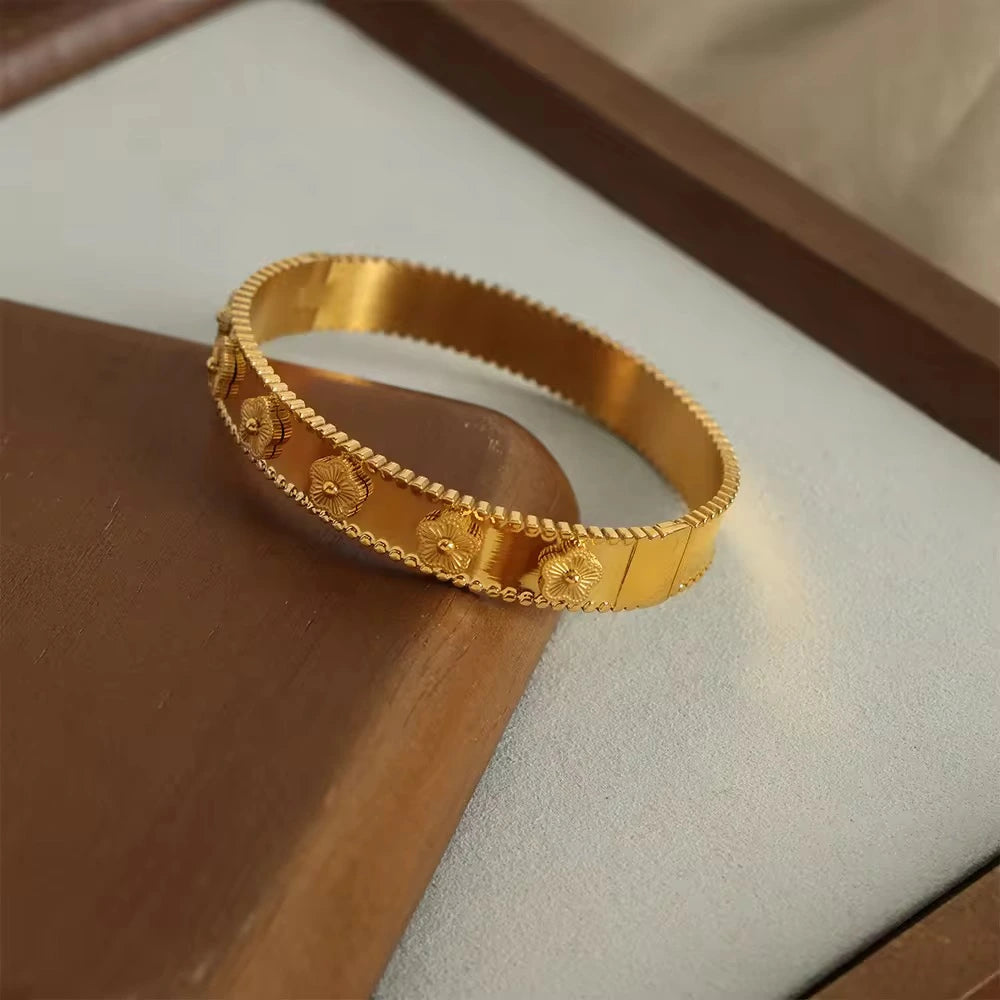 Gold bracelet on a wooden surface