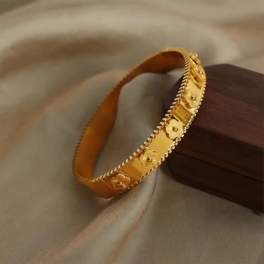 Gold bracelet on a soft fabric background