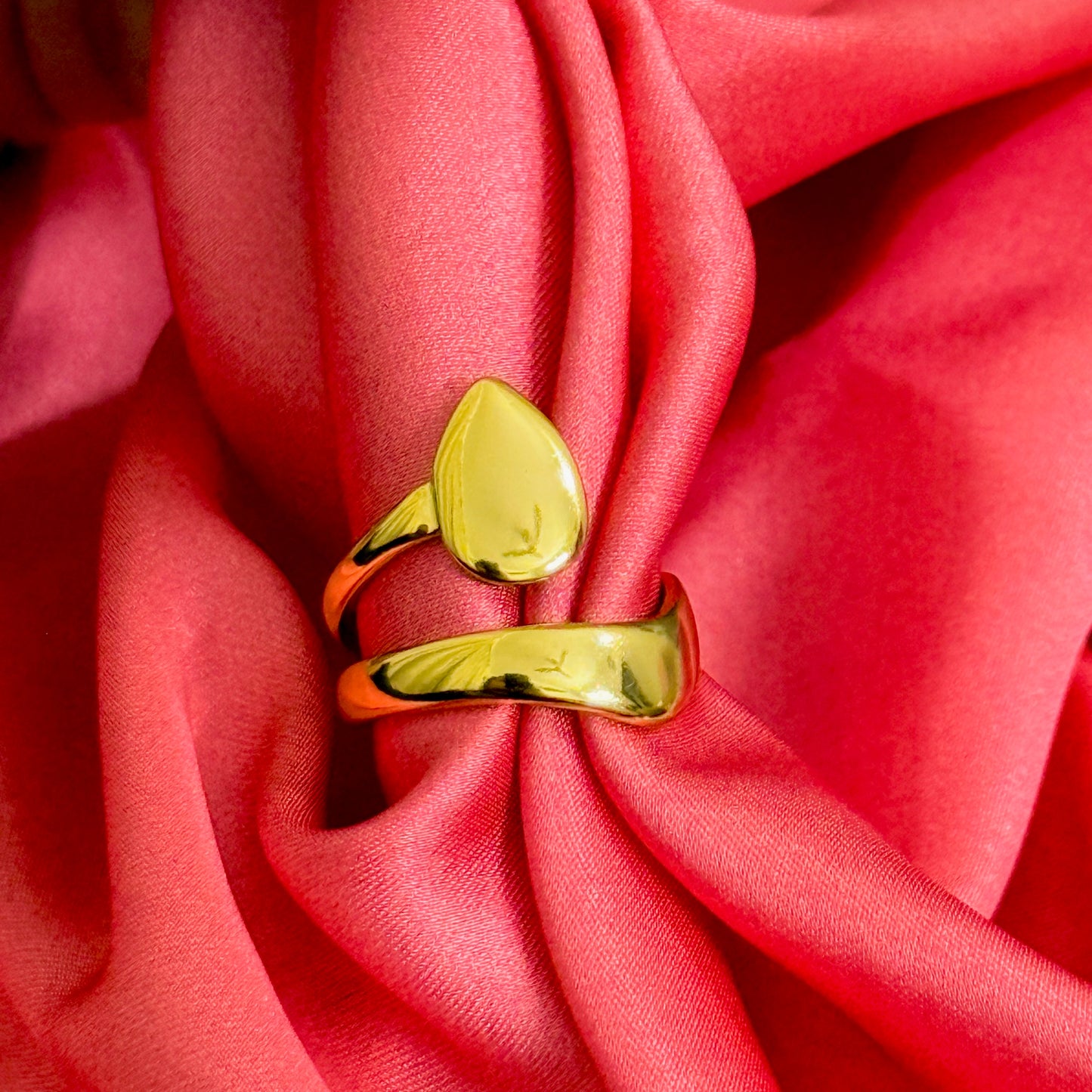 Gold ring on a red fabric background
