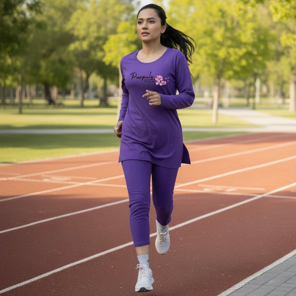 Woman running on a track wearing a purple outfit with a brand logo.