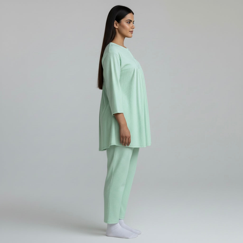 Woman wearing a light green outfit on a plain background