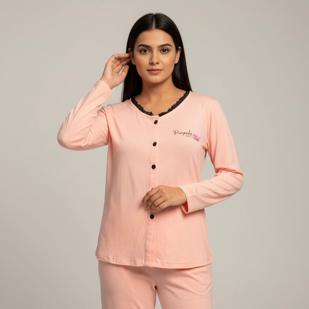 Woman wearing a pink pajama set with a logo on a gray background