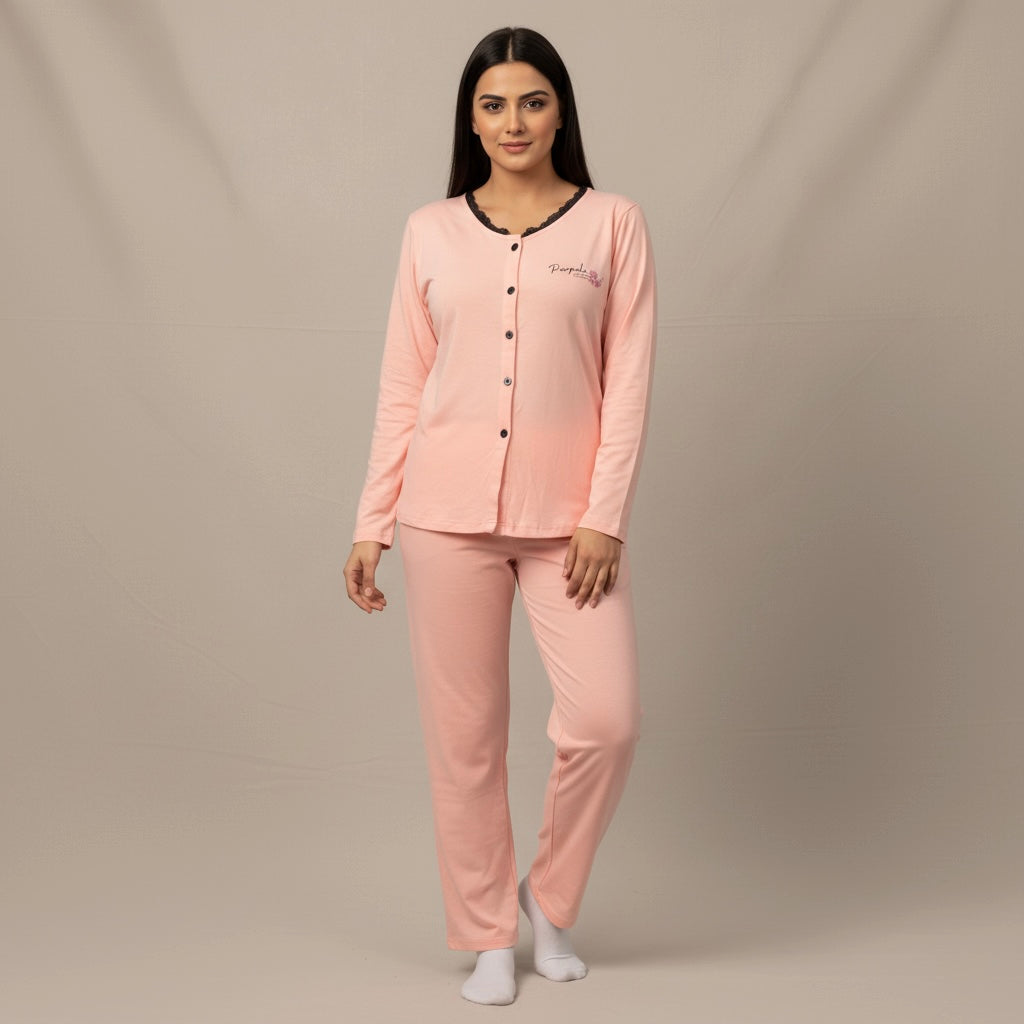 Woman wearing a pink pajama set against a beige background