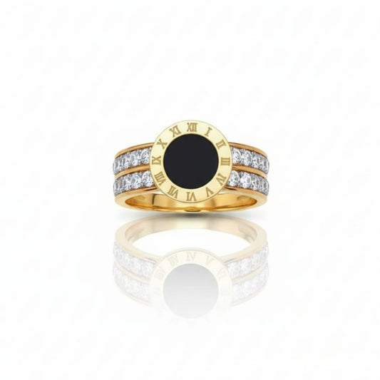 Gold ring with a black center and diamond accents on a white background