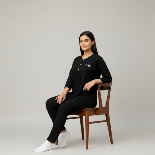 Woman wearing a black outfit with a subtle design.