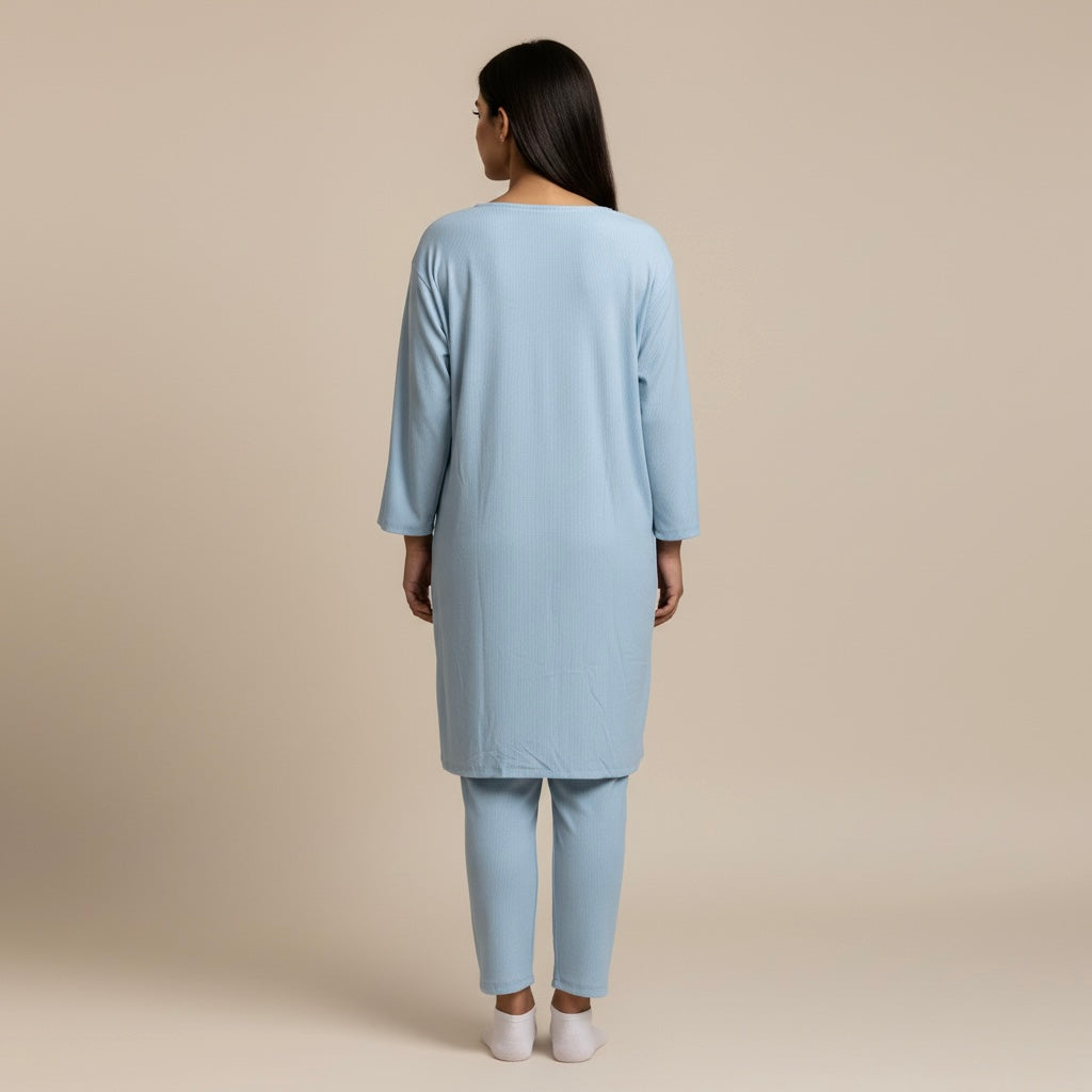 Woman wearing a light blue outfit on a beige background