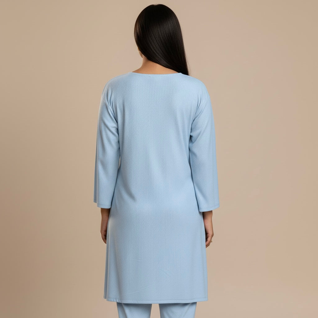 Light blue kurta worn by a person on a beige background