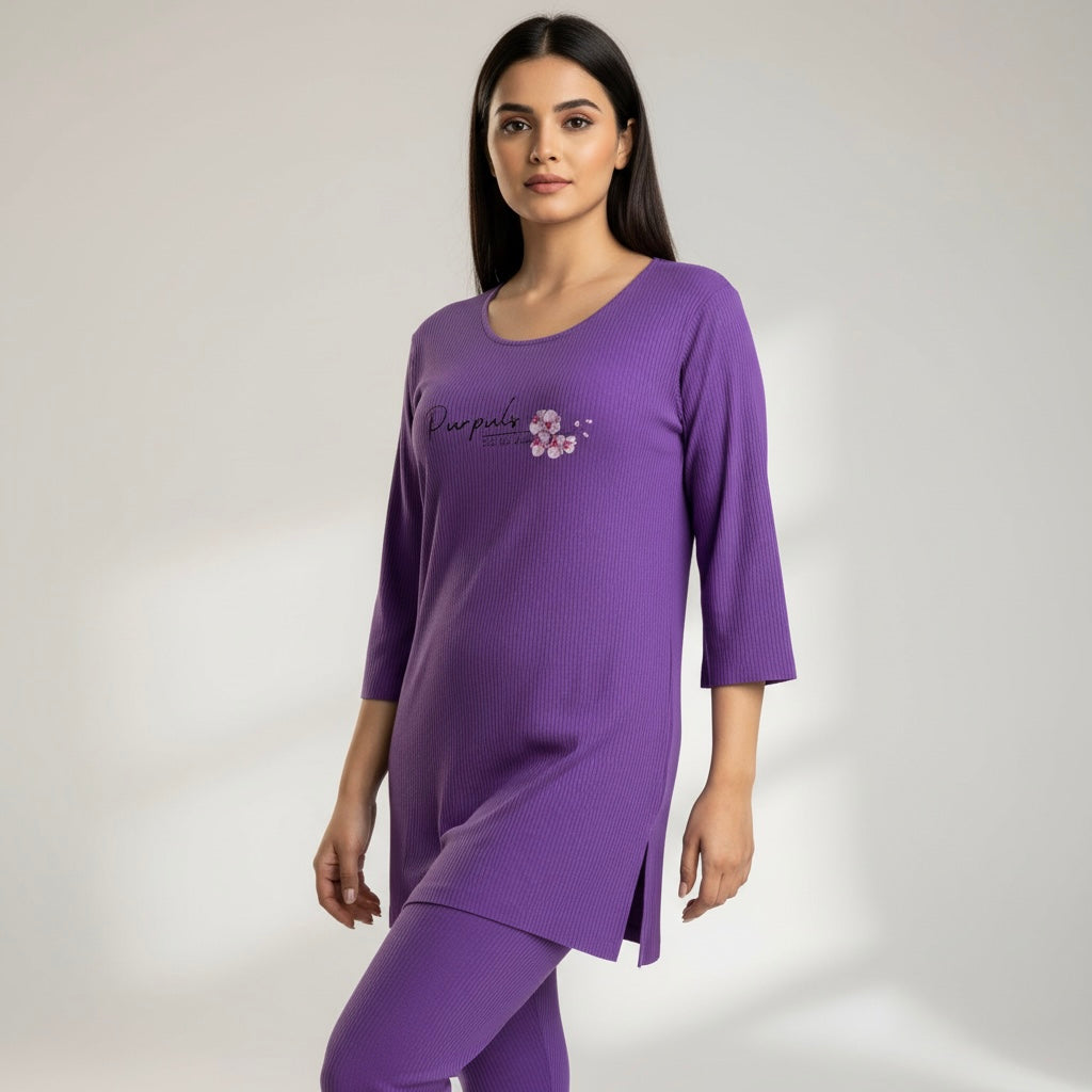 Woman wearing a purple outfit with a brand logo on a light gray background