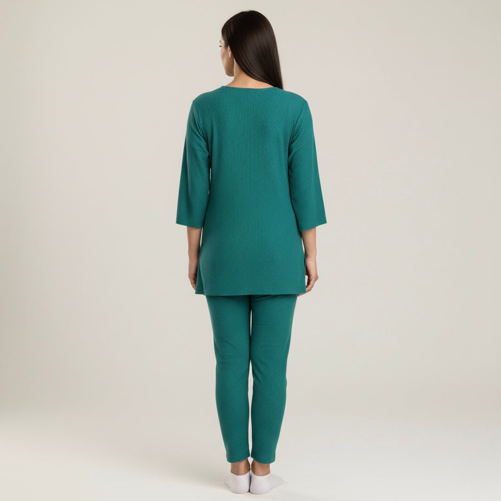 Woman wearing a teal outfit on a plain background