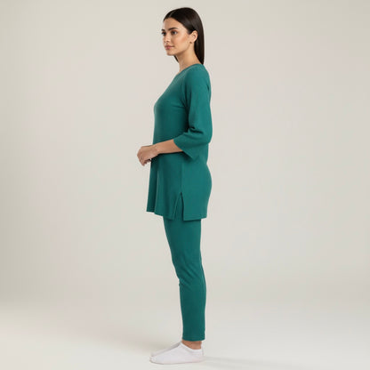Woman wearing a teal outfit on a white background