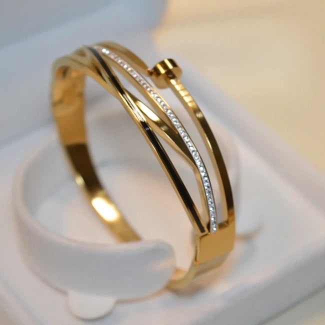 Gold bracelet with engraved text on a white background