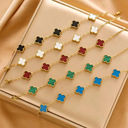 Colorful clover-shaped necklace on a beige surface