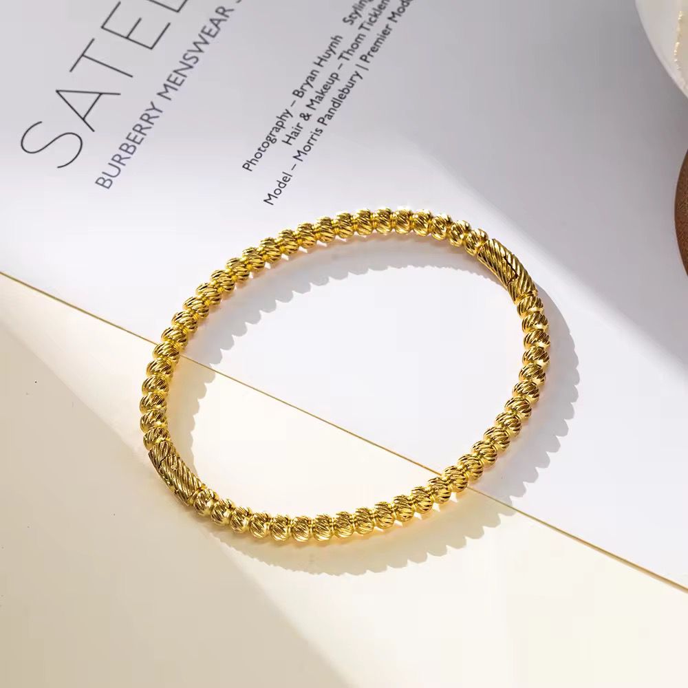 Gold bracelet on a Burberry magazine