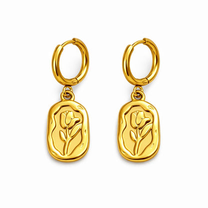 Gold hoop earrings with tulip-shaped charms on a white background