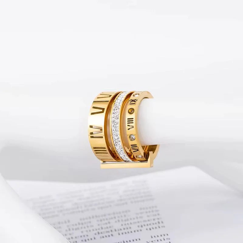 Gold hoop earrings with Roman numeral design on a white background
