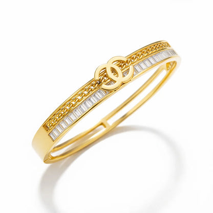 Gold bracelet with white stones on a white background