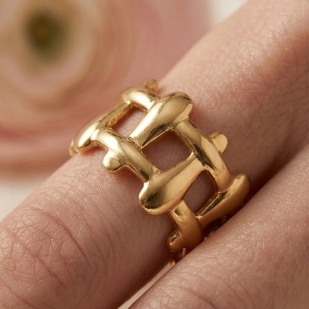 Gold ring on a finger with a soft background
