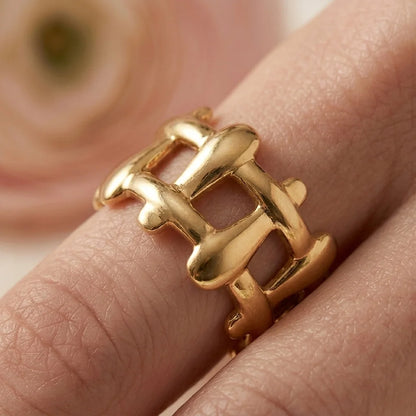 Gold ring on a finger with a soft background