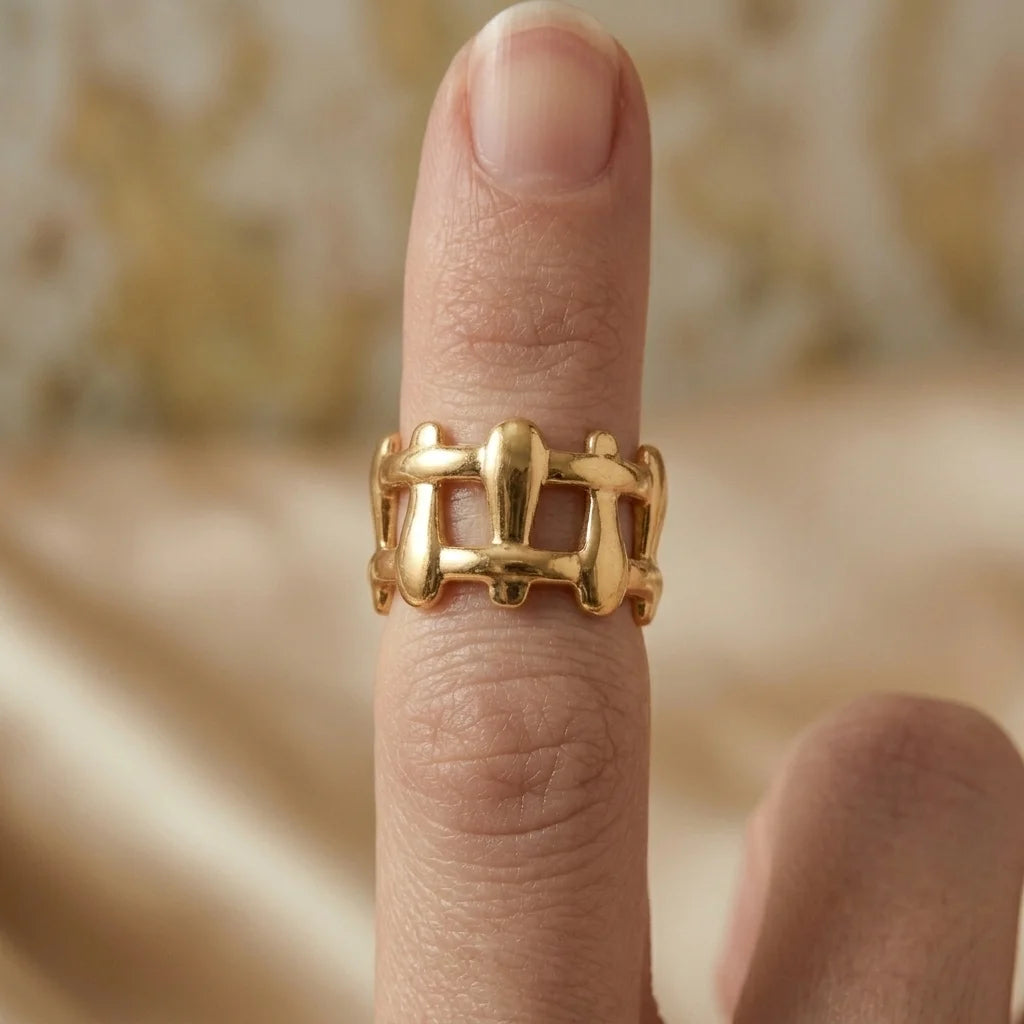 Gold ring on a finger with a blurred background
