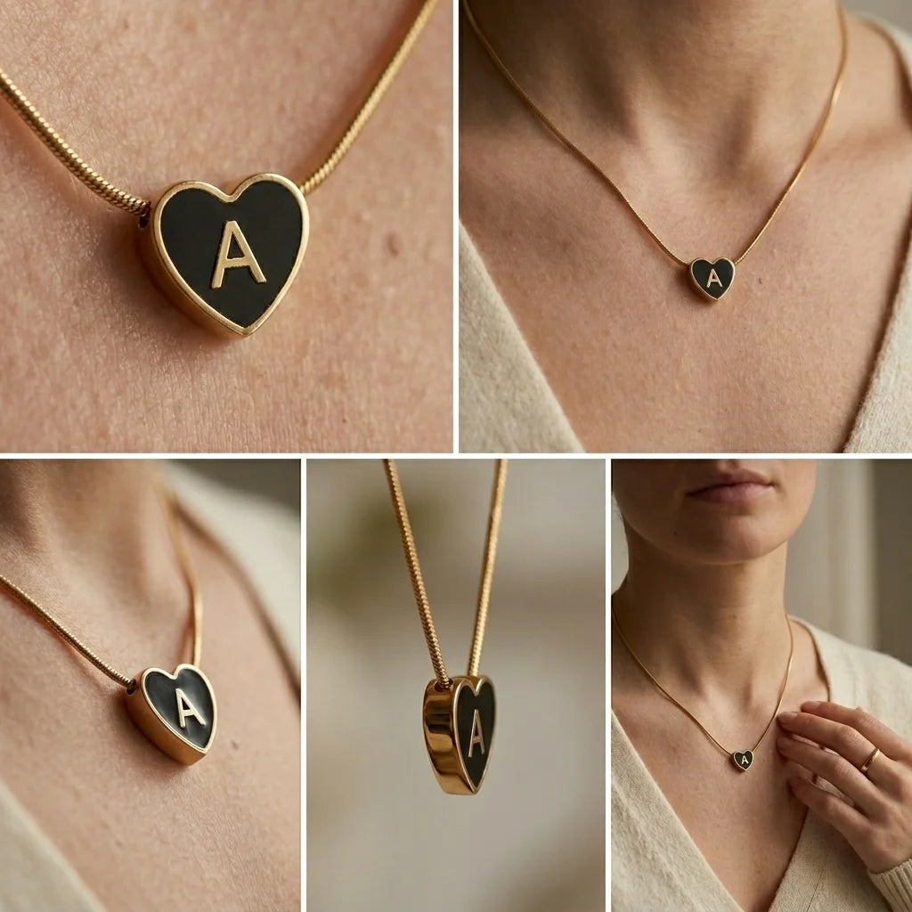 Heart-shaped necklace with a gold chain and letter 'A' pendant on a person wearing a beige sweater.