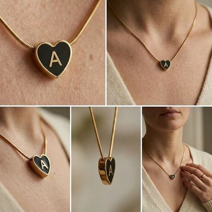 Heart-shaped necklace with a gold chain and letter 'A' pendant on a person wearing a beige sweater.