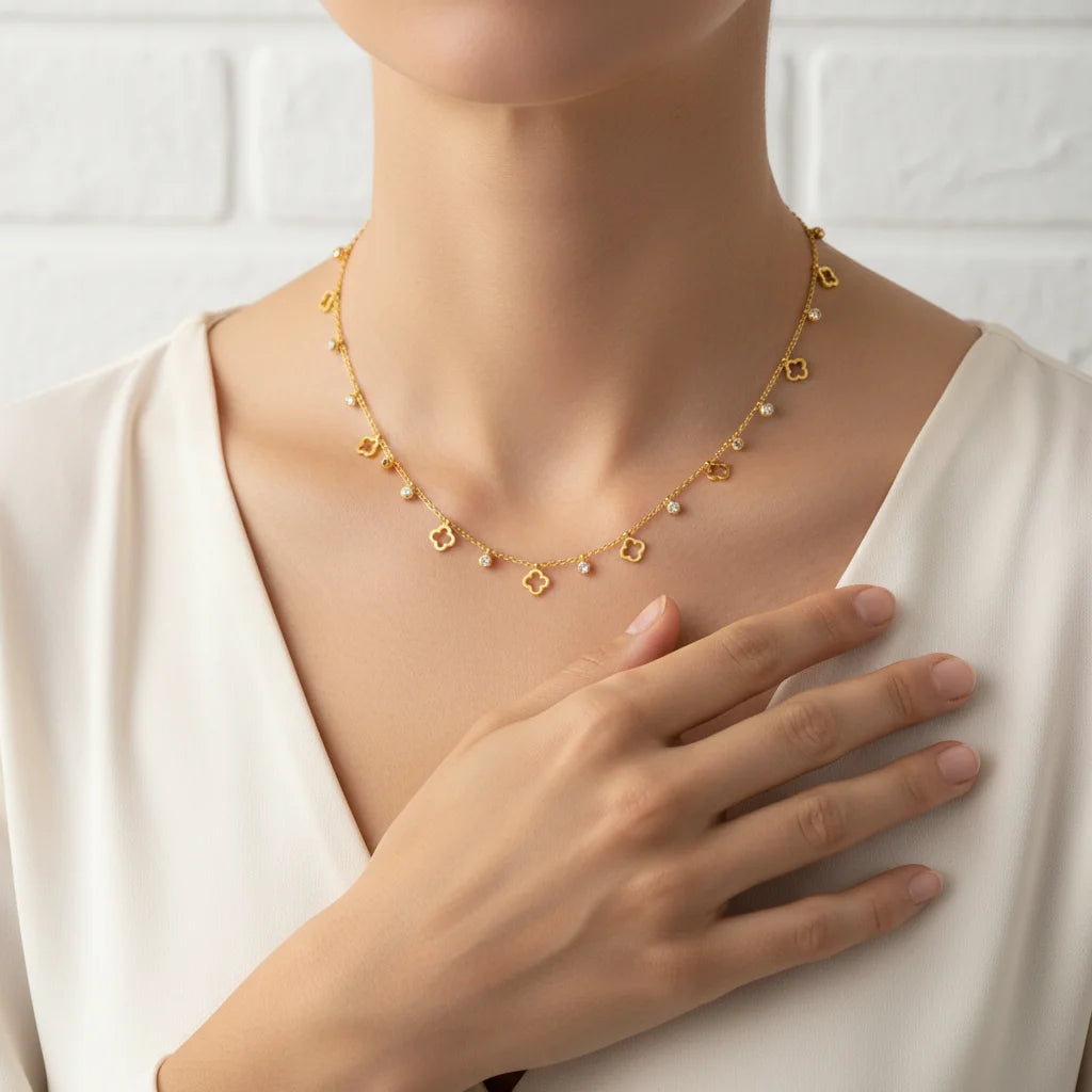 Gold necklace worn by a model with a white background